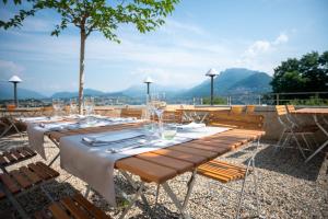 a group of tables and chairs with wine glasses at Bigatt Hotel & Restaurant in Lugano