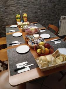 a table topped with plates and bowls of food at Affittacamere Casadio in Cotignola