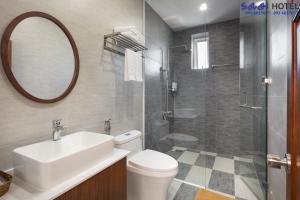 a bathroom with a toilet and a sink and a shower at SALAH HOTEL in Quy Nhon