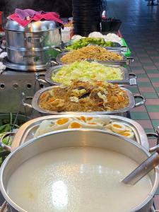 
a buffet table with plates of food and utensils at Wankou Hotel in Zhongzheng
