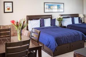 A bed or beds in a room at Riptide Oceanfront Hotel