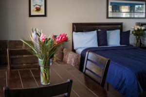 A bed or beds in a room at Riptide Oceanfront Hotel