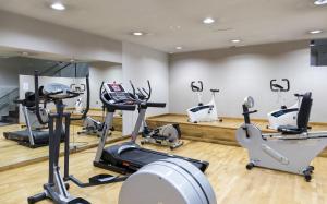 a gym with several treadmills and elliptical machines at Parador De La Seu D'urgell in La Seu d'Urgell