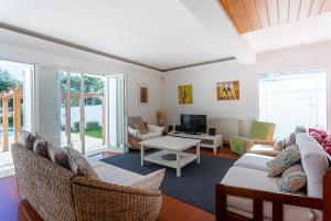 a living room with a couch and a table at Villa Flora in Sesimbra