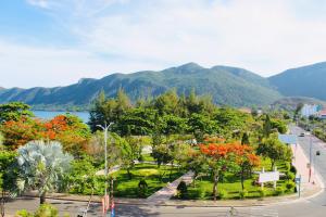 a view of a park with mountains in the background at Minh Minh Homestay in Con Dao