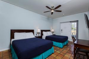 
a bedroom with two beds and two lamps at Sugar Apple Bed and Breakfast in Christiansted
