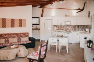 a kitchen with a couch and a table and chairs at Casa rural con piscina en Hoya de Tunte - 4 in San Bartolomé