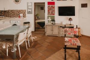 聖巴托洛梅的住宿－Casa rural con piscina en Hoya de Tunte - 4，一间带桌椅的厨房和一台电视