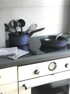 a kitchen stove with a pot and pans on it at Appt 5pers Centre St Jean de Luz - Calme - Grande Plage à 2mn - Balcon in Saint-Jean-de-Luz