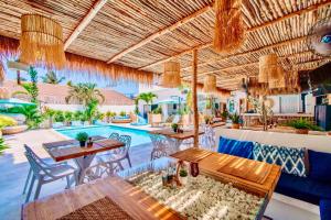 a patio with tables and chairs and a pool at So KohKoon Beach Resort in Bang Rak Beach