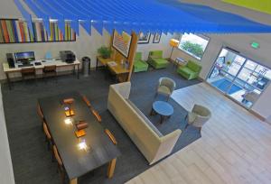 an overhead view of a living room with a table and chairs at Holiday Inn Express Hotels & Suites Burlington, an IHG Hotel in Burlington