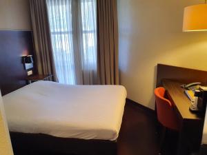 Postel nebo postele na pokoji v ubytování Golden Tulip Ampt van Nijkerk