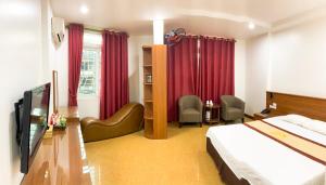 a hotel room with a bed and red curtains at Hanoi Star Hotel in Hanoi