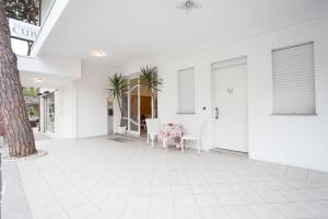 a white porch with a table and chairs at Residence Cuba in Riccione