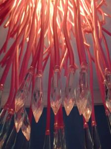 a bunch of wine glasses hanging from a chandelier at CSI Coimbra & Guest House - Student accommodation in Coimbra