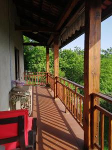 a wooden porch of a house with trees in the background at Le Viole Bianche in Albiano dʼIvrea