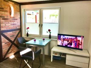 TV a/nebo společenská místnost v ubytování Ferienhaus Till & Lotte