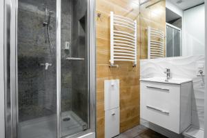 a bathroom with a shower and a sink at Dream Aparts - Rewolucji in Łódź