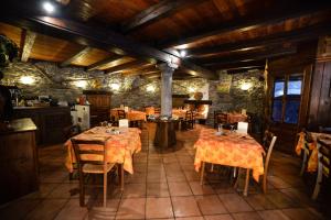 a restaurant with tables and chairs in a room at Chalet Della Guida in Bardonecchia