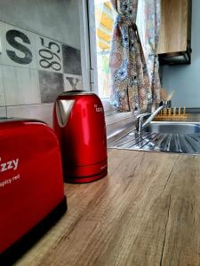 a red toaster sitting on a counter in a kitchen at Nefeli in Livadi