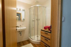 a bathroom with a shower and a sink at Apartmán 15 MyMara in Bešeňová