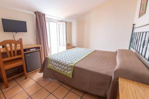 Posteľ alebo postele v izbe v ubytovaní Hostal El Gallo