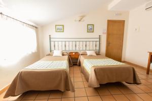 Posteľ alebo postele v izbe v ubytovaní Hostal El Gallo