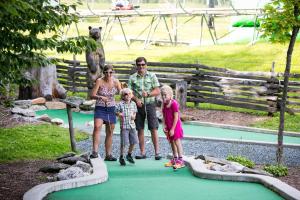 a family posing for a picture at a zoo at Mountain Lodge at Okemo-1Br Fireplace & Updated Kitchen condo in Ludlow