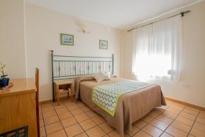 Posteľ alebo postele v izbe v ubytovaní Hostal El Gallo
