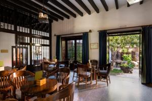 a restaurant with wooden tables and chairs and a patio at Parador de La Gomera in San Sebastián de la Gomera