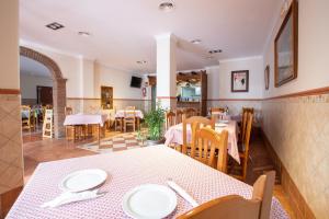 a dining room with a table and chairs at Hostal El Gallo in Marbella