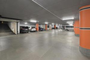 an empty parking garage with cars parked in it at Hotel Roberta Alpine Adults only in Livigno