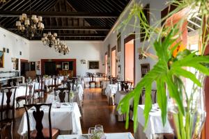 a dining room with white tables and chairs at Parador de La Gomera in San Sebastián de la Gomera