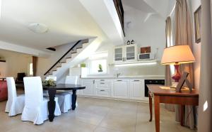 a dining room with a table and a kitchen at Effie Perine Apartments in Bled