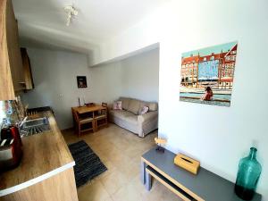 a living room with a couch and a table at Nefeli in Livadi