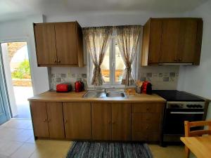 a kitchen with a sink and a window at Nefeli in Livadi