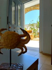 a sculpture of a turtle on a table in front of a door at Nefeli in Livadi