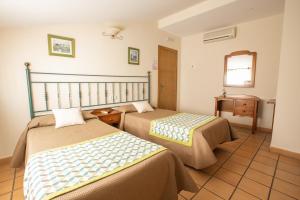 Posteľ alebo postele v izbe v ubytovaní Hostal El Gallo