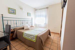 Posteľ alebo postele v izbe v ubytovaní Hostal El Gallo
