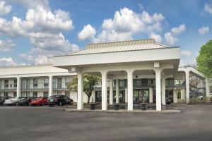 a large white building with a parking lot at Baymont by Wyndham Murfreesboro in Murfreesboro