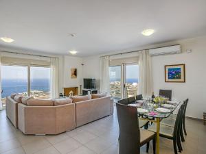 a living room with a couch and a table at Dilira Villas in Agia Pelagia