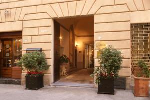 an entrance to a building with two potted plants at Graziella Patio Hotel in Arezzo