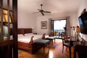 a bedroom with a bed and a table and chairs at Parador de La Gomera in San Sebastián de la Gomera