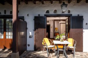 a dining room with a table and chairs and a door at Parador de La Gomera in San Sebastián de la Gomera