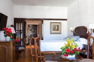 a bedroom with a bed and a table and chairs at Parador de La Gomera in San Sebastián de la Gomera