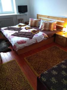 a bedroom with two beds and two rugs at Vysoké Tatry Gerlaška in Svätý Jur