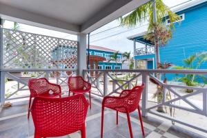 a patio area with chairs, tables and umbrellas at Brisa Oceano Resort in Placencia