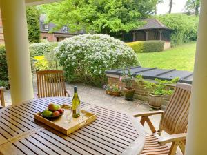 a table with a tray of fruit and a bottle of wine at The Garden Suite in Basingstoke