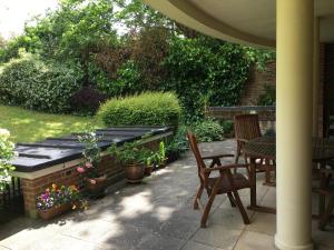 a patio with a table and chairs and plants at The Garden Suite in Basingstoke