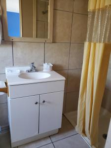 a bathroom with a sink and a shower curtain at PineCrest Inn & Suites in Flagstaff